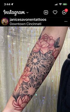 a woman's arm with flowers on it and an instagramr above the wrist