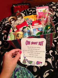 a person is holding a small gift box filled with candy and other things to put in it