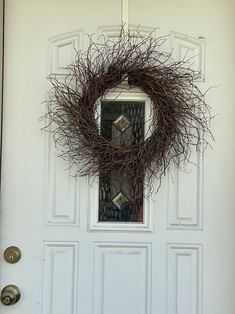 a wreath hanging on the front door of a house