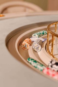 several casino chips are sitting on a tray next to a glass jar with a lighter in it