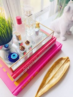 three trays stacked on top of each other with bottles and plants in the background