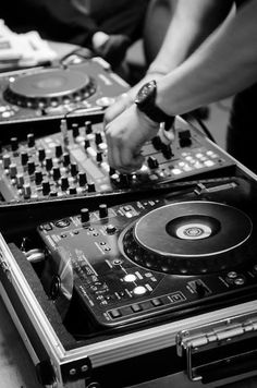 two people are playing music on their turntables