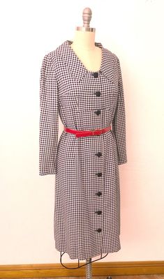 "Vintage 1960's classic shirtdress. Woven white and navy checkered pattern. Enlarged collar, empire waist with a working buttondown front. Slim darted sleeves. Inside is completely lined with dark navy acetate. Wear belted or not - comes with a red belt. Buttondown front has additional snaps on the waist. Handmade and in excellent pre-worn condition. Best fits a size medium. --- M E A S U R E M E N T S --- Measurements are taken flat and doubled. Fits like medium Bust: 36\" Waist: 34\" Hips: 36\ Formal Houndstooth Long Sleeve Dress, Formal Long Sleeve Houndstooth Dress, Plaid Collared Dress For Work, Formal Houndstooth Dress For Fall, Classic Button-up Business Dress, Classic Fitted Plaid Dress, Vintage Plaid Workwear Dress, Vintage Plaid Dress With Button Closure, Fitted Vintage Plaid Dress With Buttons