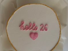 a white cake with pink frosting and the word hello 25 written on it in large letters