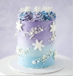 there is a blue and purple cake with flowers on it