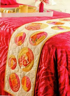 an image of a bed with pink and yellow bedspread