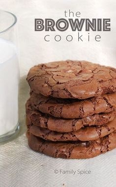 the brownie cookie is next to a glass of milk