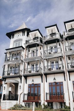 a large white building with lots of windows and balconies