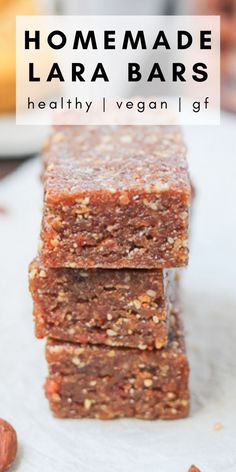 homemade lara bars stacked on top of each other with nuts and almonds in the background