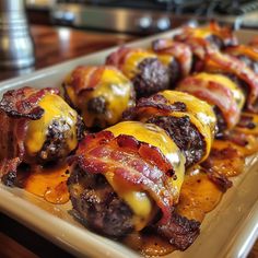 bacon wrapped in cheese on a white plate