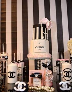 a chanel themed birthday party with black and white striped wallpaper, chanel cake