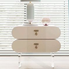 a table with two drawers and a lamp on top