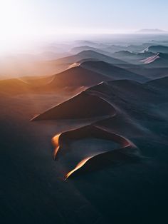 the sun shines brightly on sand dunes