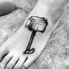 a black and white photo of a foot with a tattoo on it