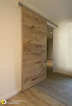 an empty room with a sliding door and hard wood flooring on the side wall