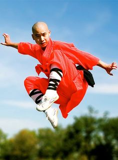 a man in an orange jumps into the air