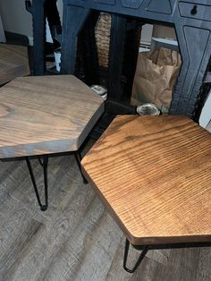 two wooden tables sitting next to each other on top of a hard wood floored floor