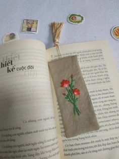 an open book with embroidered flowers on it