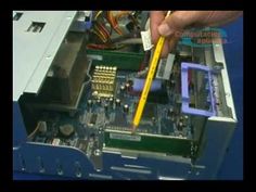 a person is holding a yellow pencil to the motherboard of a computer that's being dismantled