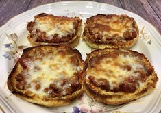 four mini pizzas on a white plate