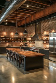 an industrial style kitchen with stainless steel appliances and wooden counter tops, along with exposed brick walls