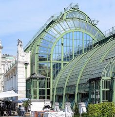 a large green glass building with many windows