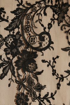 black and white lace with flowers on the bottom is seen in this close up photo