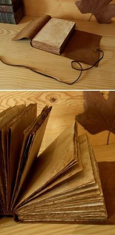 an open book sitting on top of a wooden table next to a pile of books