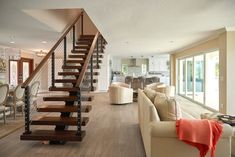 a living room filled with furniture and a stair case