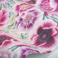 a pink floral wallpaper with large flowers on it's back and side panels