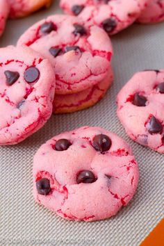 chocolate chip cookies with pink icing and red sprinkles