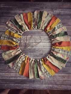 a wreath made out of fabric on top of a wooden table