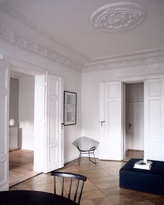 a living room filled with furniture and white walls