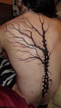 a woman with a tree tattoo on her back