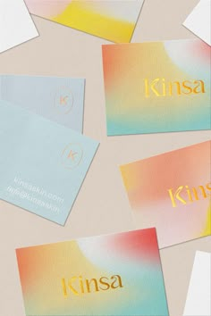 four business cards with the name kinsa printed on them, all in different colors