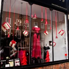 a storefront with red and white decorations in the front window, along with other items on display