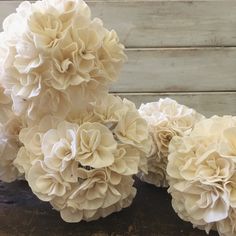 some white flowers sitting on top of a wooden table