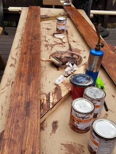 some paint cans are sitting on top of a table