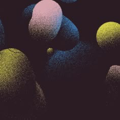 an image of some balls in the dark with colored dots on them and black background