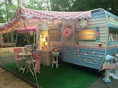 an old trailer is decorated with pink and blue decor