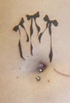 a woman's stomach with tattoos on it and three flowers drawn on the side