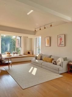 a living room filled with furniture and large windows