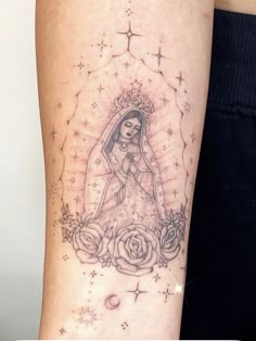 a woman's arm with a tattoo on it that has an image of a bride and roses