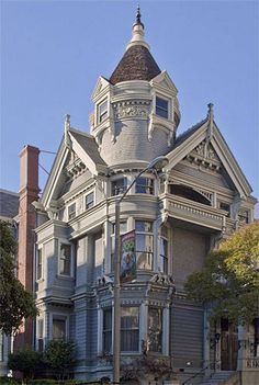 an old victorian style house with a clock tower