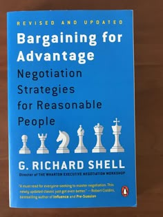 a blue book with white chess pieces sitting on it's cover and the title, bargaining for advantage