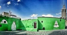 the green buildings are painted in different colors