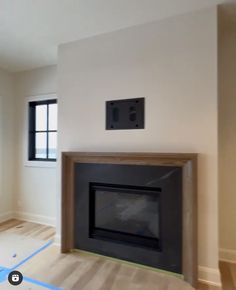 an empty living room with a fire place