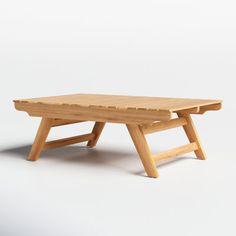 a wooden table sitting on top of a white floor