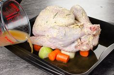 there is a turkey and carrots on the plate with gravy being poured onto it