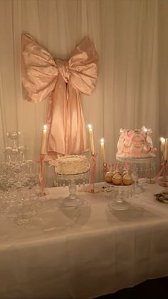 a table topped with lots of cakes and candles